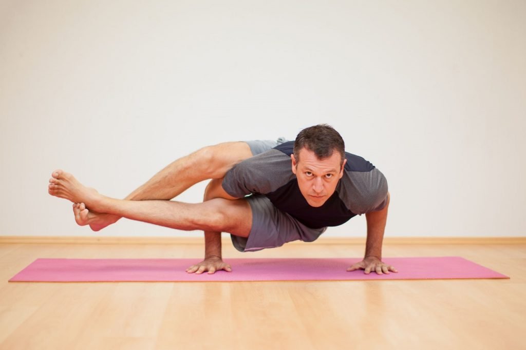 Woman Practicing Gorilla Pose Yoga Exercise Stock Photo by ©rognar 3831571